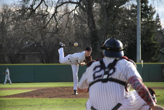 Junior Stuart Bradley warms up before an inning against Menlo College on Jan. 30. Photo credit: Jacob Auby
