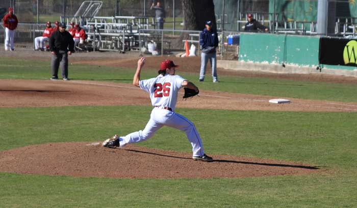 Senior pitcher A.J. Epstein winds up to pitch against Menlo College on Jan. 31. Photo credit: Cam Lesslie