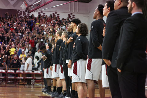 The mens basketball team lines up during the National Anthem in a game against Cal Poly Pomona. 