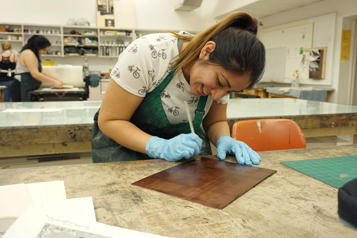 Jazmin Gonzalez, senior art major with an emphasis in printmaking, came across the art of printmaking in the studios and classrooms of Chico State. Photo credit: Floritzel Salvador