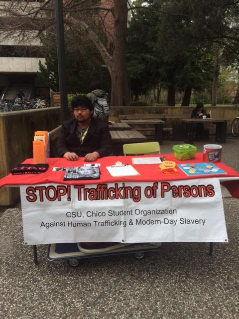 Vincent Le runs the booth for Stop Trafficking of Persons. Photo credit: Molly Sullivan