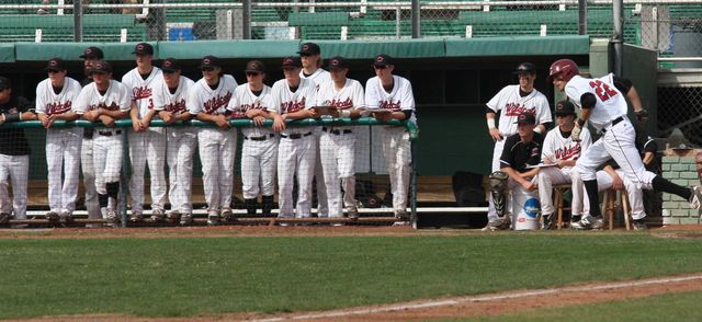 The Chico State dugout looks on after junior infielder Casey Bennett sprints to first. Photo credit: Allisun Coote