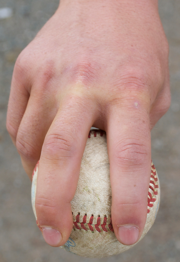 Junior pitcher Clayton Gelfand displays his four-seam fastball grip on the baseball. Photo credit: Danielle Pubill