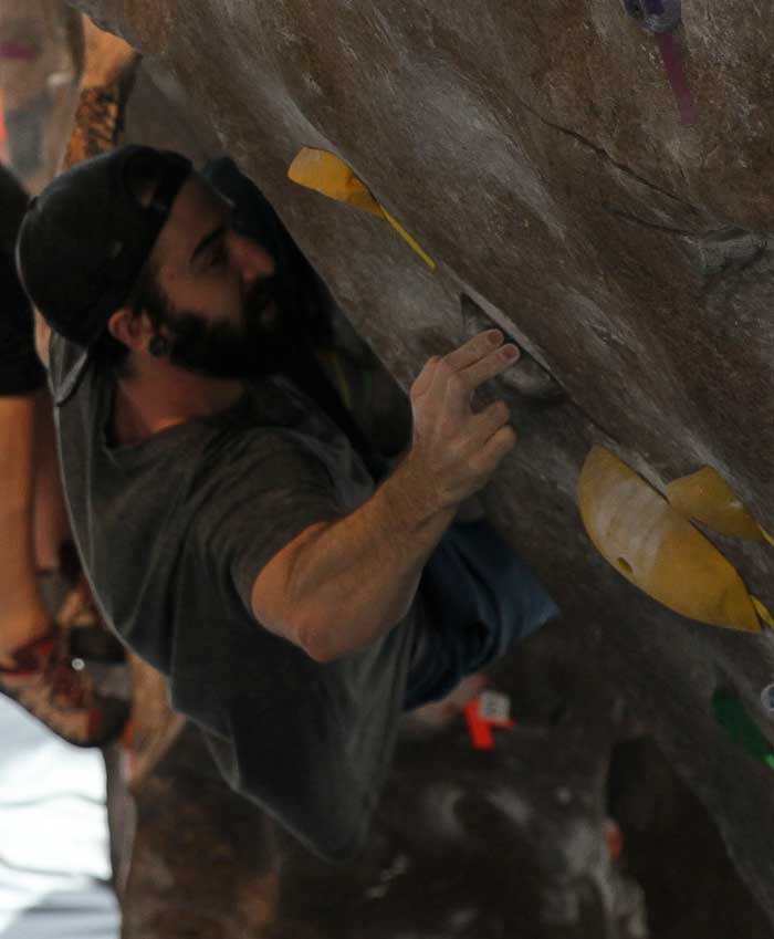 Climber Justin Caswell climbs along side his fellow competitors. 