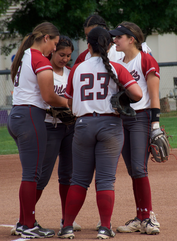 The Chico State softball team talks between innings in a game against Cal State Dominguez Hills. Photo credit: Nick Martinez-Esquibel