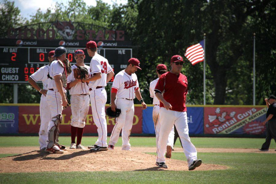 Head coach Dave Taylor walks off the mound after talking with his team. Photo credit: Jacob Auby