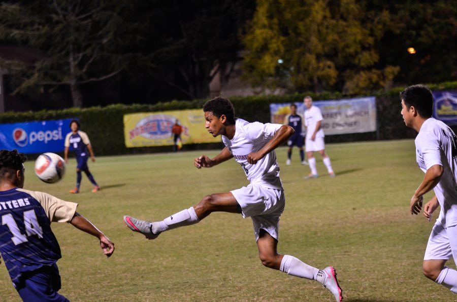 Junior Isaiah Dargan boots the ball on the fly in a game last fall. Photo credit: Ryan Pressey