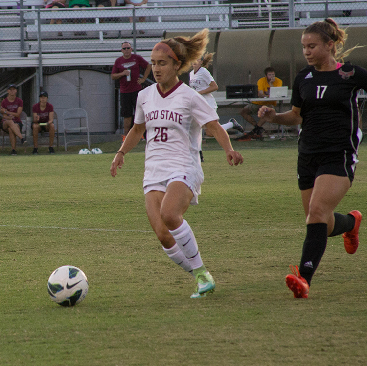 Junior defender Brooke Coelho attempts to pass the ball to a teammate. Photo credit: Aubrie Coley