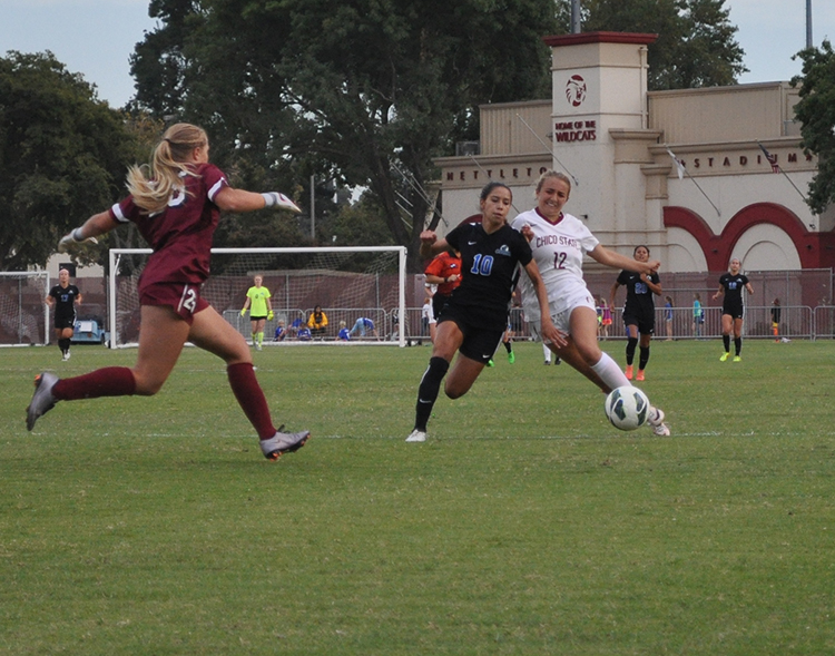 First-year forward Abbie Jones battles for the ball as first-year goalkeeper Caylin Stanley rushes to assist. Photo credit: Makayla Hopkins