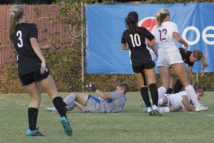 First-year goalkeeper Caityln Duval struggles to get up after being knocked down with first-year forward Sarah Yang. Photo credit: Aubrie Coley