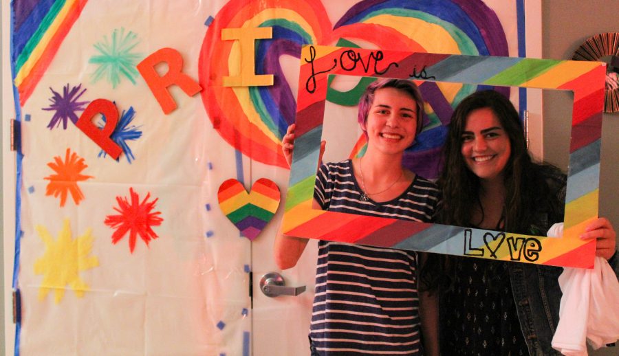 First-year biology major, Sophia Balme (right) and first-year business administration major, Tyler Wallace (left), take advantage of the Pride themed interactive photo booth. Photo credit: Jae Siqueiros