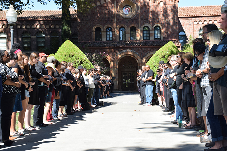 Members of the Chico State community gather in front of Kendall Hall during a silent protest. Photo credit: Royal T Lee-Castine