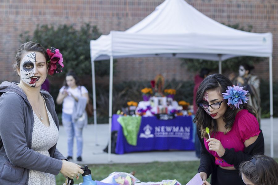 Junior communication major Amy Rodrigues (left), enjoys a Twizzlers at the outside portion of the event. A friend involved invited her to get her face painted while she was attending the event.

Senior Jessica Godinez (Right) helps a young attendee with some arts and  crafts at the second day of the event. As a transfer student from the Bay Area, Godinez didnt see much diversity when she first came to Chico. She was in culture shock and found Mecha. She loved what they stand for: social activism and bringing students together. Photo credit: Jordan Rodrigues