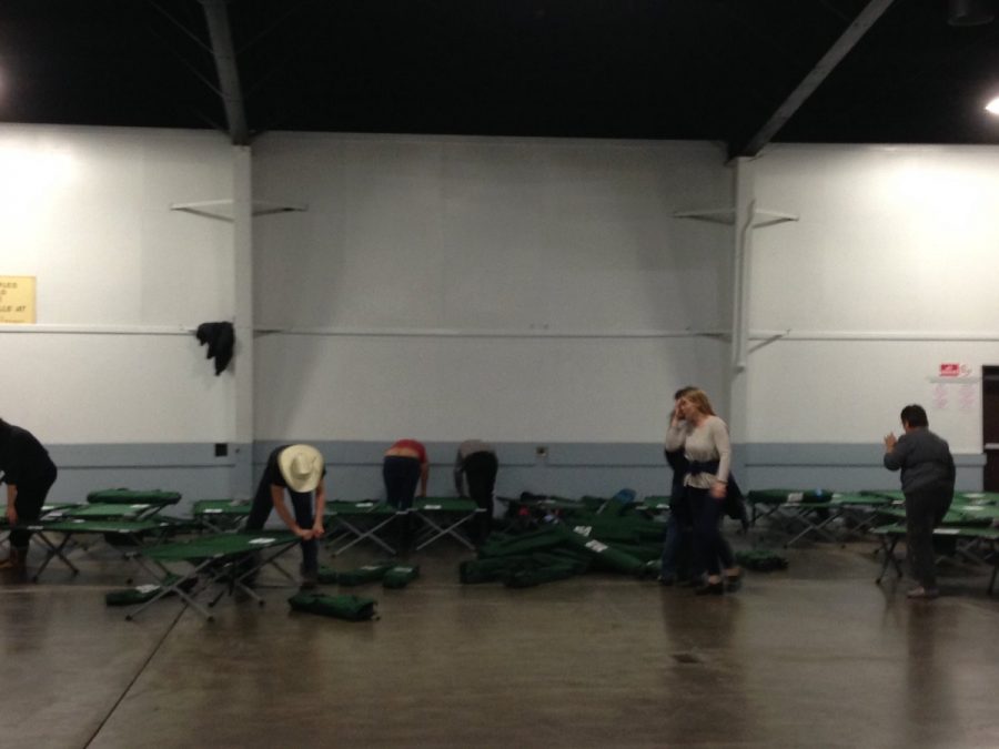 Volunteers set up cots at the Silver Dollar Fairgrounds evacuation center. Photo credit: George Johnston