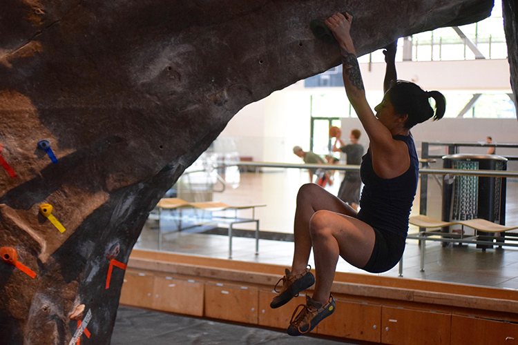 Climber Miranda Santana hangs from the boulder as she attempts to pull herself back up. Photo credit: Miguel Orozco