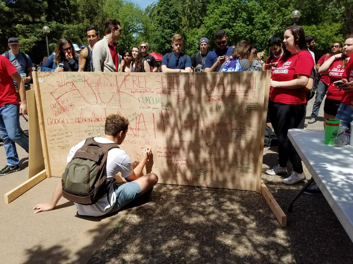 Student writing on "Free Speech" wall Photo credit: Daniel Wright
