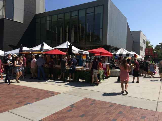 Booths and food stands outside the new Arts and Humanities building.