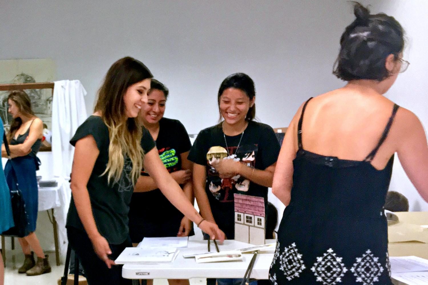 (From left to right) Patty Huerta, Jazmin Gonzalez, Mai Thao and Madison assembling all moving parts of their Attack on Titan performance-like presentation of its storyboard. Photo credit: Alejandra Solorio