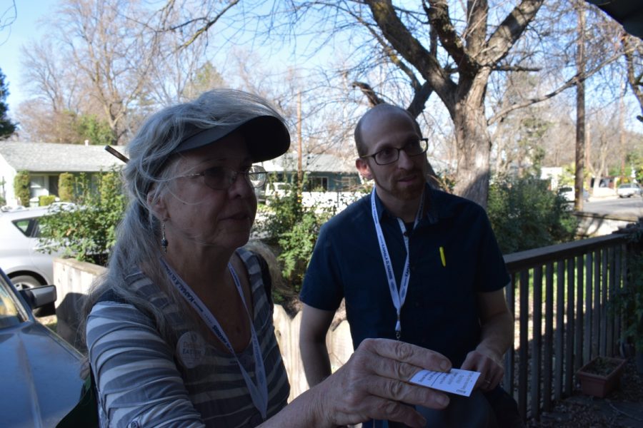 Robin Keehn and Asa Mittman hand out information about voter training to a Chico resident. Photo credit: Alex Grant