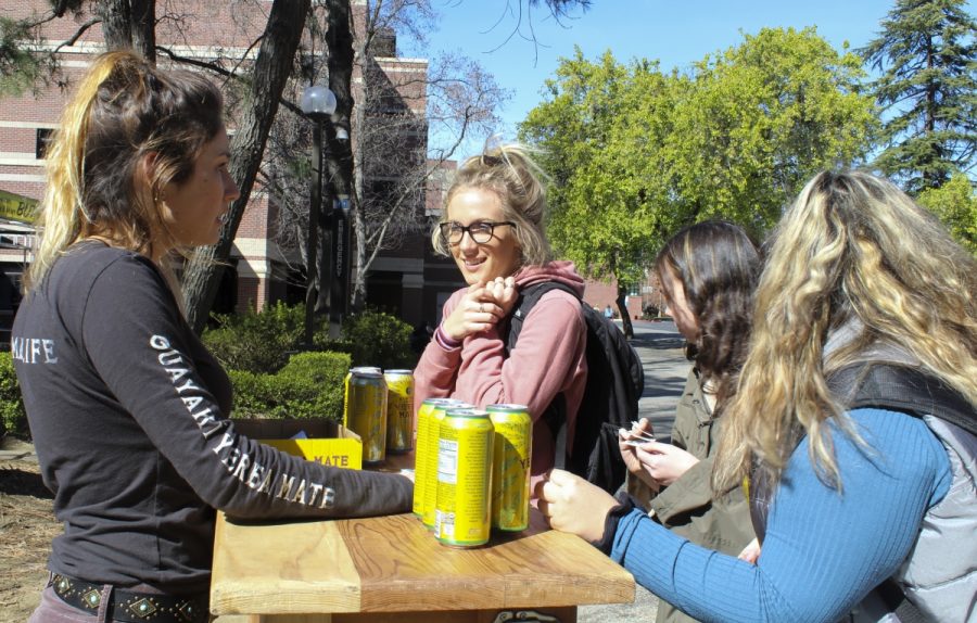 Students eagerly crowd a pop-up Yerba Mate stand outside of Plumas Hall, to collect free drinks and learn about the Yerba college ambassador program on Tuesday afternoon. Photo credit: Anne Chamberlain