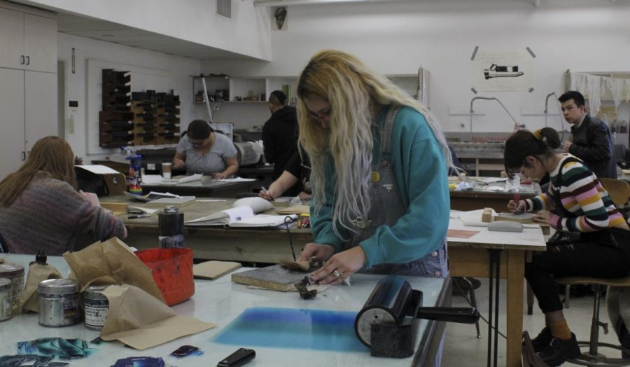 Intro to Printmaking students Sonya Gaysinskiy, Jillian Harris-Rivera, and Valerie Hill hard at work on their linoleum block relief prints at Ayres Hall Monday morning. Photo credit: Anne Chamberlain