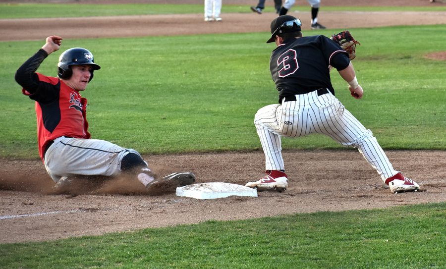 Cameron Santos, right, tries to tag out Kyle Redford, left, at third base in the top of the first in the second February 9 game against Northwest Nazarene.