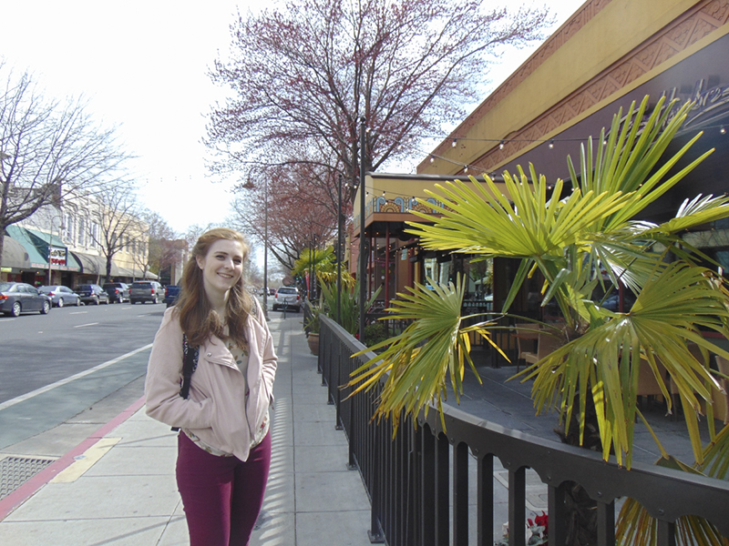 Kailyn Erb stands next to a section of the planned march route on Broadway Street. Photo credit: Lizzie Helmer