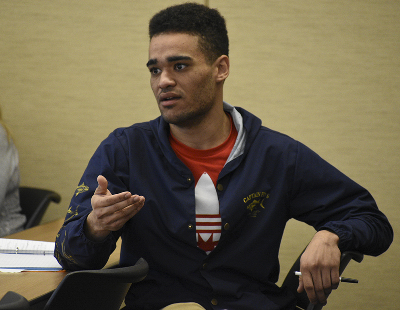 Political Science major Forrest Osburn asks the panel at a fee forum on March 7 about why low-income students would have to pay the same amount as students like himself who can afford the fee increases.
