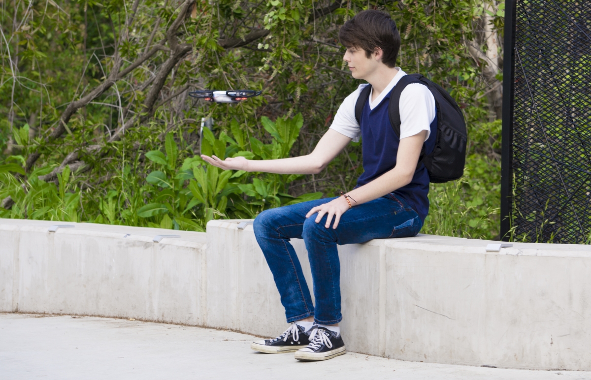Fares Husseini (off-frame) flies a drone into Zachary Frandsen's hand. Photo credit: Carly Maxstone