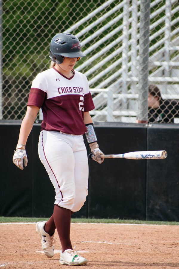 Chico States softball catcher makes her way up to the plate to bat. Photo credit: Kate Angeles