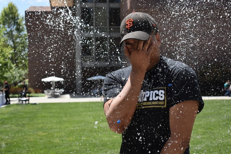 Santos Arevalo of Epsilon Sigma Rho braces himself for a water balloon attack on Tuesday of dead week. The fraternity set up water balloons ready to be tossed at the fraternity members in Trinity Commons to relieve finals stress. Photo credit: Caitlyn Young