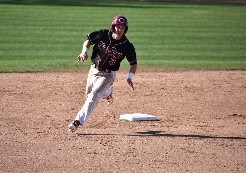 Wildcats third baseman Cameron Santos rounds second base in a matchup against Fresno Pacific. Photo credit: Martin Chang