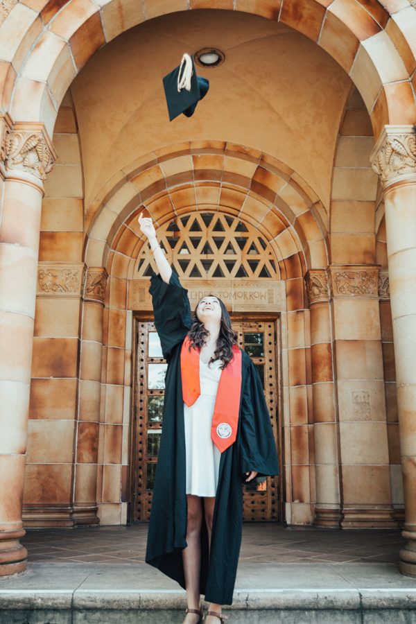 Graduation is around the corner and graduating senior Savannah McGhghy throws her cap in the air in front of Kendall Hall. Photo credit: Kate Angeles