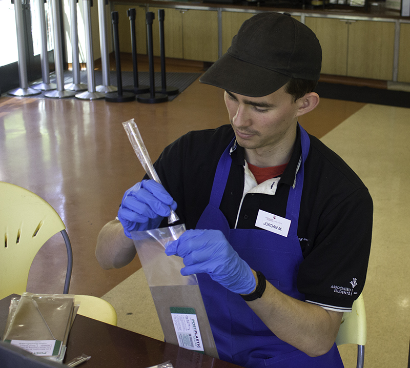A.S. Dining Student Lead Jordan Menkes assembles a Post Plastic straw kit on May 2.