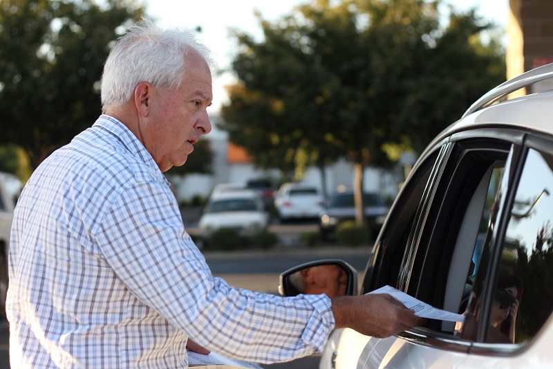John Cox greets people gassing up at the Chico Costco, Friday, talking about Prop. 6, the gas tax repeal. Photo credit: Caitlyn Young