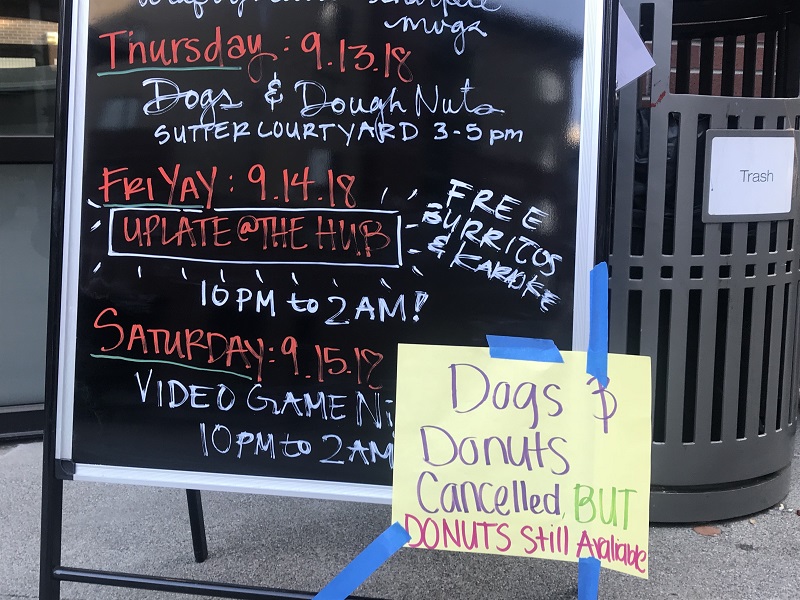 HUB Happening board with a Dog and Donuts canceled sign that broke students hearts Photo credit: Justin Jackson