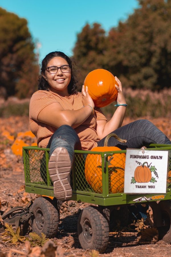 Student Kelly Portillo excited about the pumpkins she got from The Hubs trip to Peterson Sisters Pumpkin Patch. Photo credit: Maury Montalvo