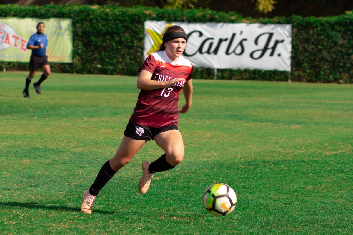 Chico State midfielder Sarah Emigh moves the ball upfield against UC San Diego on Saturday. Photo credit: Maury Montalvo
