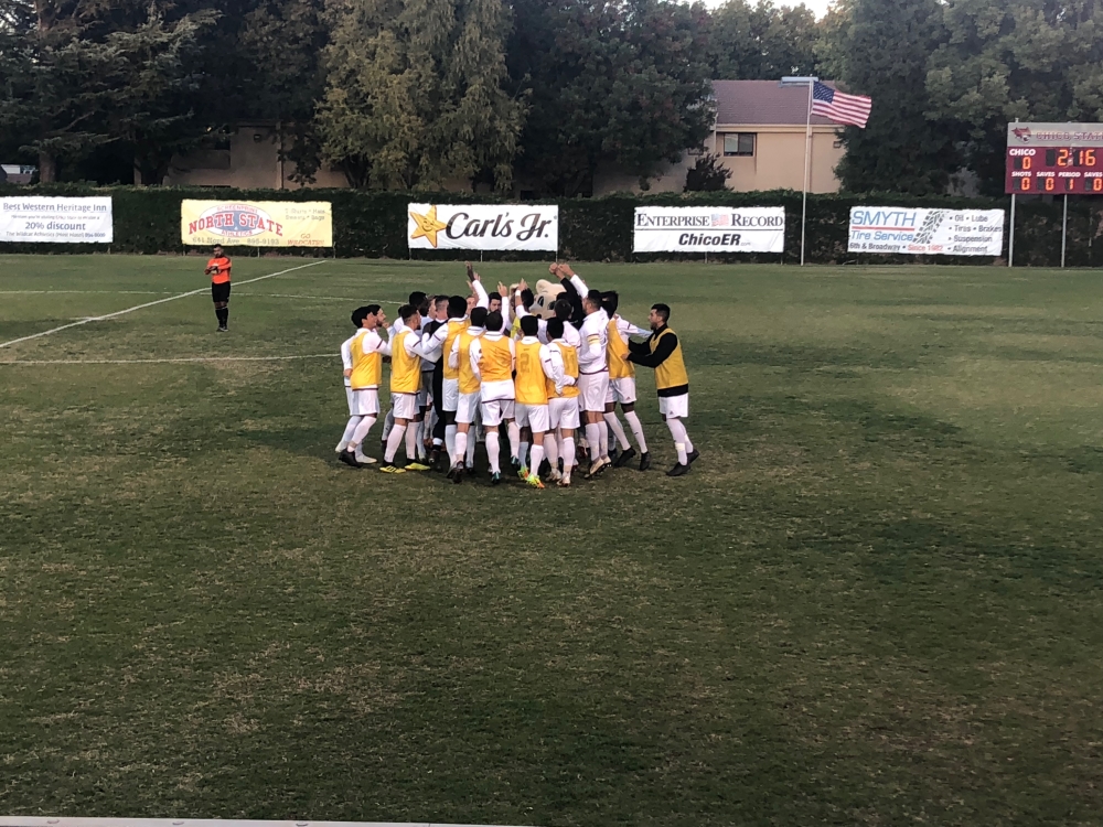 Chico State men's soccer huddles up before their playoff game against UC San Diego on Tuesday. Photo credit: Connor Mcpherson