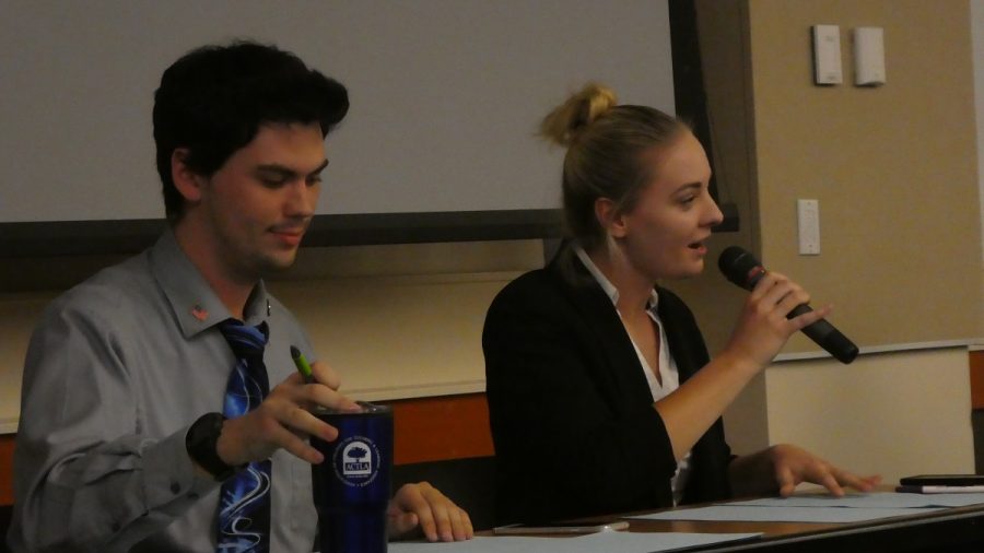 Christian Wilson,(left) and Kelsey McCaffrey (right), debate on the side saying that YouTube has done more harm than good for democracy. Photo credit: Josh Cozine