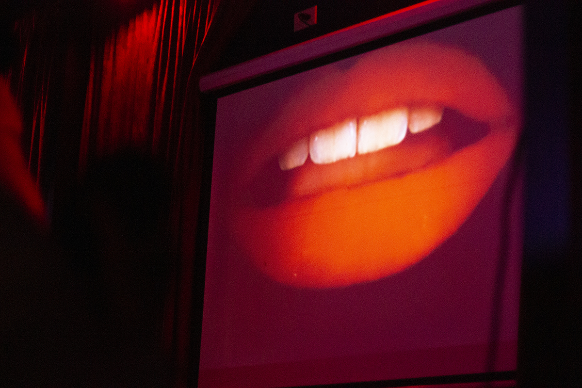 Patricia Quinn (Magenta) lips grace the screen at the beginning of the movie during the Rocky Horror Picture Show viewing at the Maltese on Halloween. Photo credit: Dominique Wood