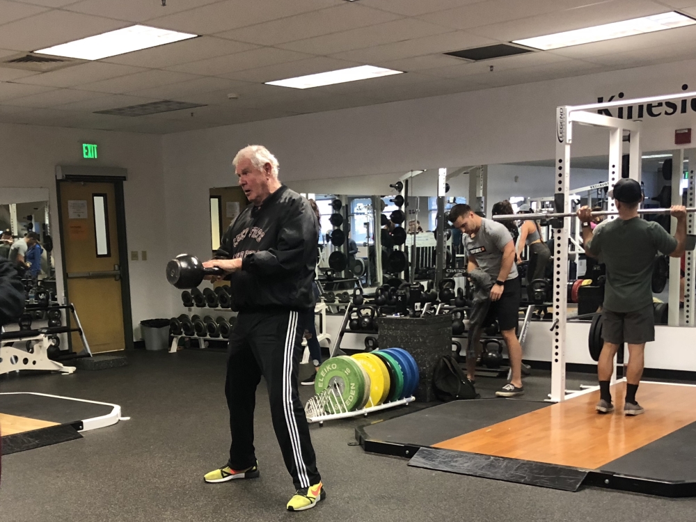 Thomas Fahey warms up with the class by doing kettlebell swings each morning. Photo credit: Mathew  Miranda