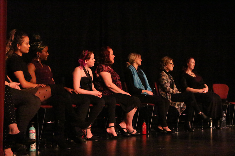 Cast Members of the Vigina Monologues sitting down while on stage. Photo credit: Rayanne Painter