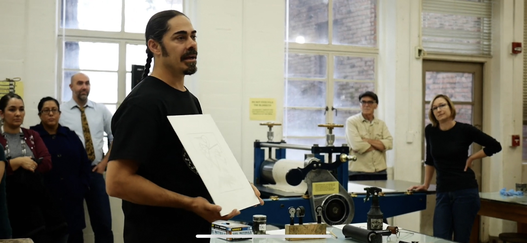 Jacob Meders giving an explanation to the crowd during his printmaking workshop. Photo credit: Melissa Herrera