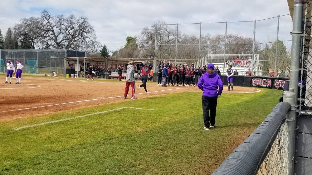 Bailey Akins celebrates her home run at home plate with her teammates. Photo credit: Brandon Downs