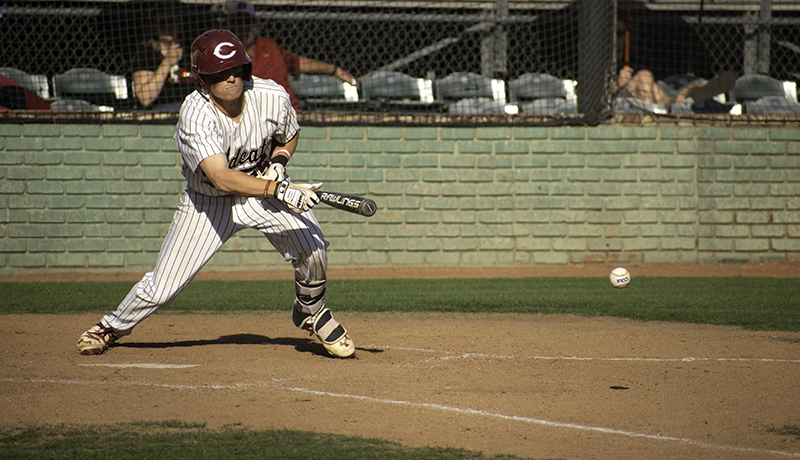 Tyler Stofiel hits a bunt and successfully gets to first, loading the bases during the second game on May 4, 2018, against Stanislaus State. Photo credit: Martin Chang