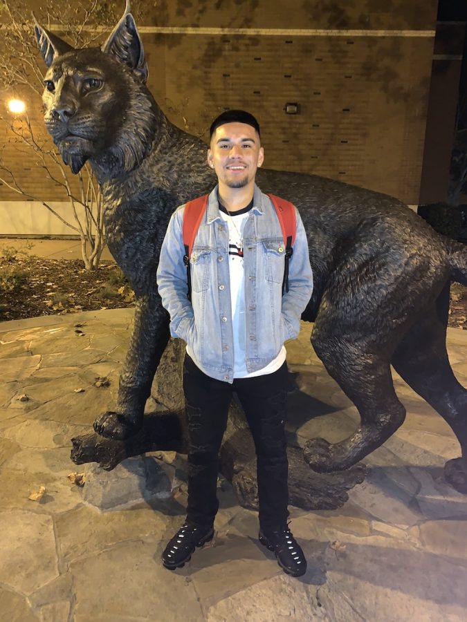 Tweeter Brian Maciel stands in front of the new wildcat statue. Image curtesy of Moises Mendoza.