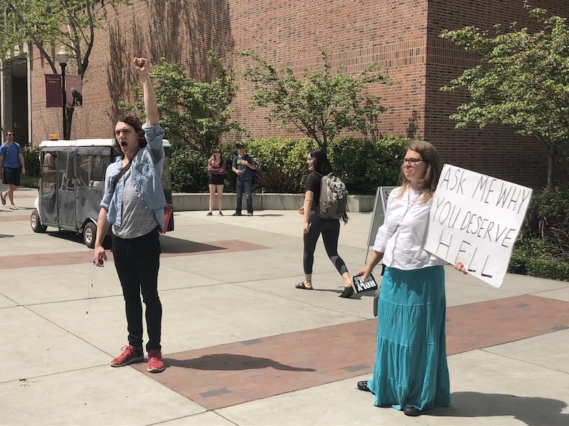 A student rallies support from onlookers at the Marketplace Cafe watching evangelist activist Sister Myrna. Photo credit: Natalie Hanson