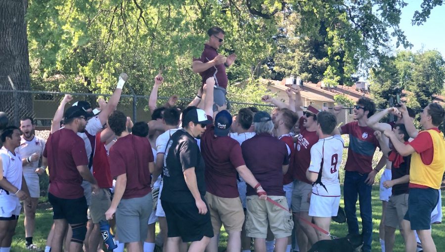 The Chico State rugby team hoist up head coach Lucas Bradbury after the win against Cal State Long Beach on Sunday. Photo credit: Ricardo Tovar