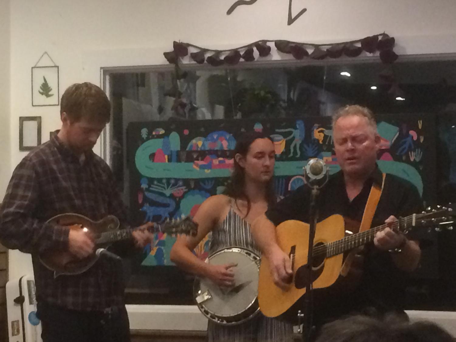 From left to right David Theissen, Christine Wilhoyte, and Steve Lawson play “Back to the Bar Room” for an enthusiastic crowd at Tender Lovin’ Coffee. Photo credit: Emily Neria